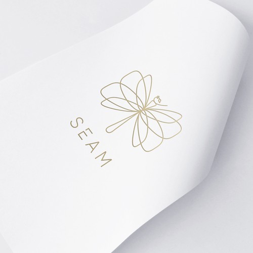 Dragonfly design with the title 'Unique Seam logo design depicting dragonfly made out of needle and thread.'