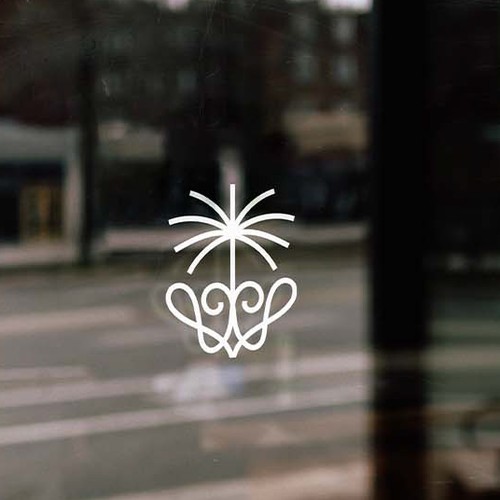 Palm tree logo with the title 'Wild as Her'