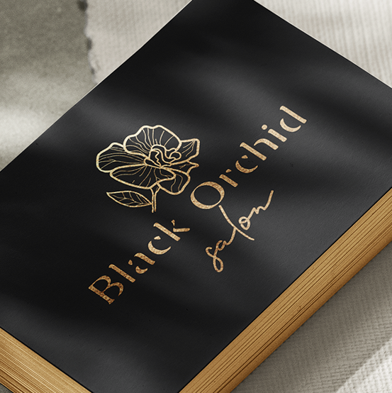 Orchid logo with the title 'An elegant black orchid logo design for a hair salon'