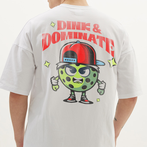 Pickle design with the title 'Dink & Dominate - Funky Pickleball Tee'